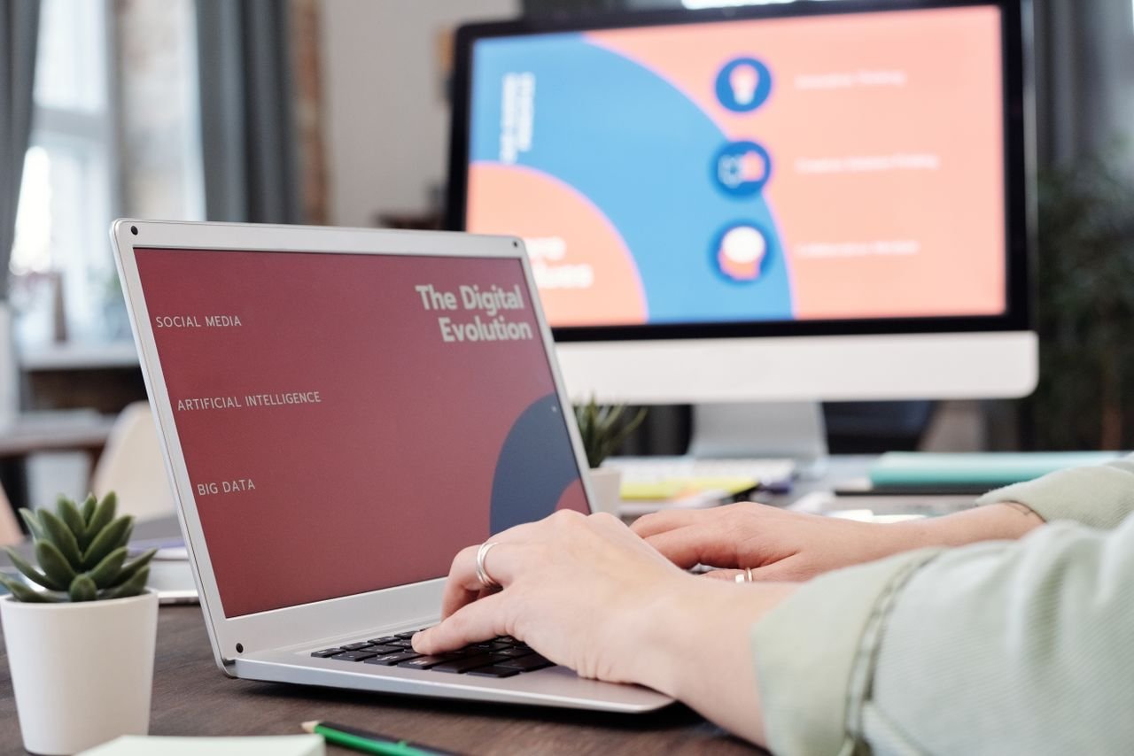Menu Laptop user typing with digital evolution concept on screen in a modern office environment.