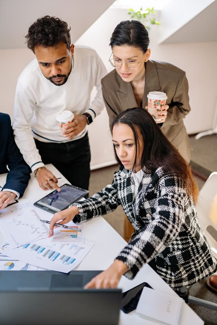 Menu Team of professionals analyzing financial data with graphs and devices in a modern office.